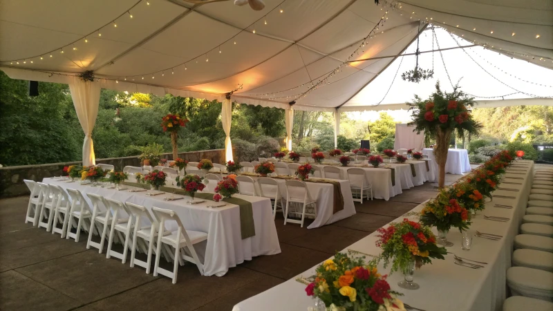 Elegant outdoor tent with banquet tables and chairs