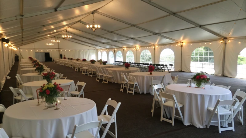 Interior view of a spacious event tent with seating arrangements