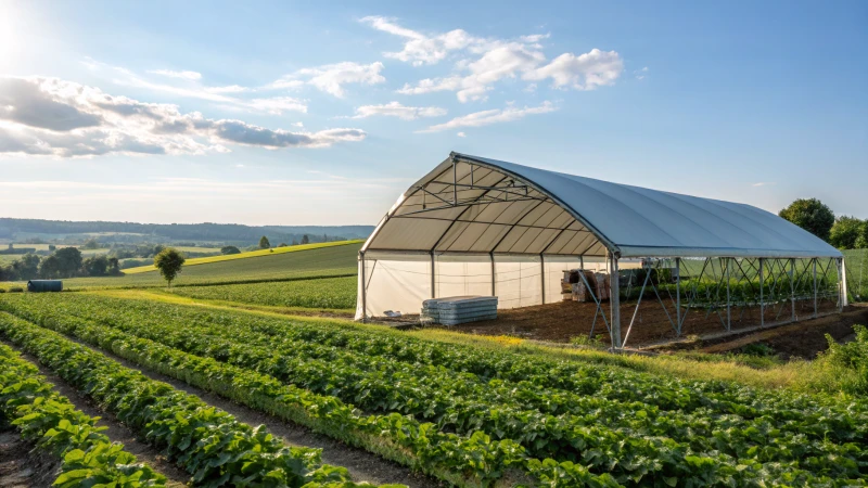 A large industrial tent in a green field