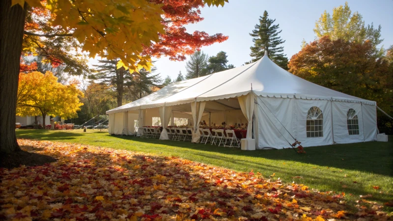 A large white tent in an outdoor setting with autumn leaves.