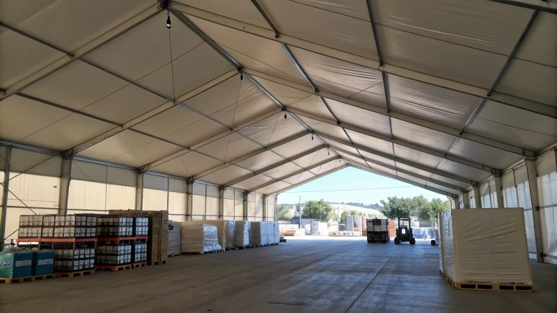 Interior view of a large warehouse tent with natural light